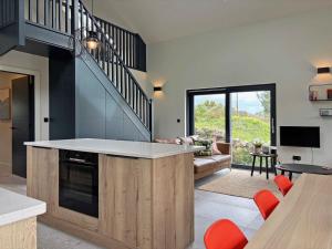 a kitchen with an island in a living room at Cottage 505 - Roundstone in Roundstone