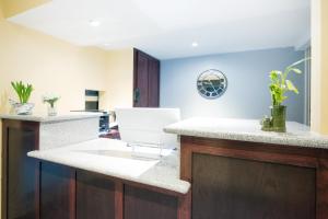 a kitchen with a sink and a counter top at Executive Inn & Kitchenette Suites-Eagle Pass in Eagle Pass