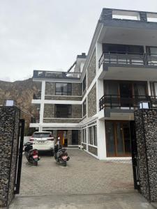 a building with motorcycles parked in a parking lot at Bön Valley in Jomsom