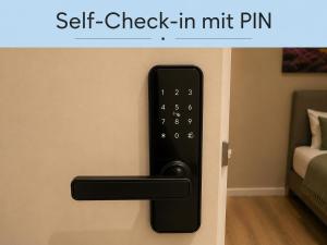 a remote control on a wall next to a bed at UNO Smart Soltau Wietzendorf in Soltau