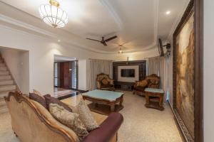 a living room with a couch and a table at Shoolin Resorts in Manipal