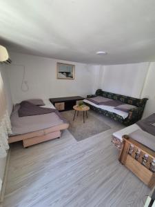a living room with two beds and a couch at Vikendica Bagremov hlad Apatin in Apatin