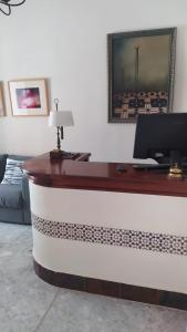 an office with a desk with a computer on it at Hostal Andalucía in Chipiona +47 photos