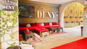 a living room with a red couch and tables at "VILLA DENY" Boutique HOTEL - with FREE PARKING in Mostar