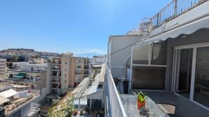 an apartment balcony with a view of a city at City Flights in Kavála