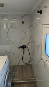 a laundry room with a cord plugged into a wall at City Flights in Kavála +7 photos
