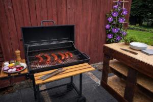 a grill with hot dogs on it next to a table at 4Rest&Fun Krušné hory in Klíny