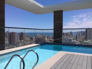 a swimming pool with a view of a city at Departamento 2 Norte in Viña del Mar