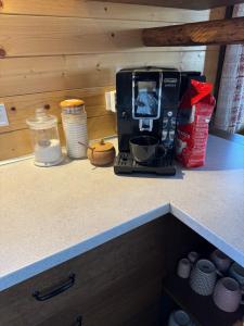 a kitchen counter with a coffee maker on a counter top at Drevenica Emilka - Sprcha, Záhradná hojdačka, Ohnisko in Brezno +33 photos