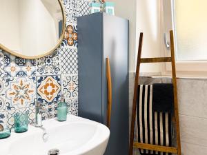 a bathroom with a sink and a mirror at Casa di Leo - HelloElba in Portoferraio