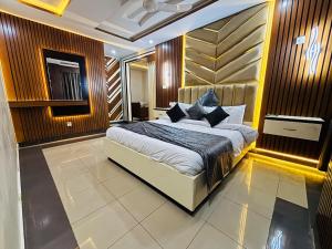 a bedroom with a large bed in a room at Sapphire Stays Hotel And Restaurant in Peshawar