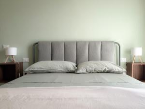 a bedroom with a large bed with two lamps at Casa di Leo - HelloElba in Portoferraio
