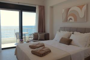 a bedroom with a bed with two towels on it at Anel Rooms in Himare