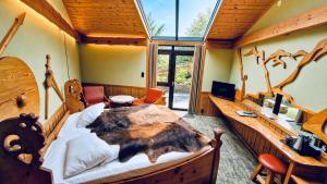a bedroom with a large wooden bed and a desk at Gudvangen Fjordtell in Gudvangen