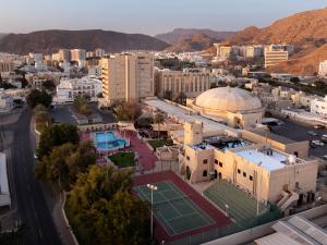 an aerial view of a city with a tennis court at Al Falaj Hotel - Secure City Escape in Muscat in Muscat