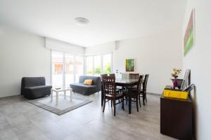 a living room with a table and chairs at Villa Livia in Toscolano Maderno