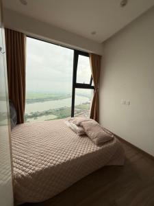 a bed in a room with a large window at Maison Joie Ecopark Lighthouse Ecorivers Hải Dương in Hải Dương +27 photos
