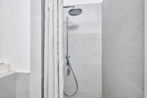 a shower in a bathroom with a shower curtain at seeglueck Altstadt Urban in Konstanz +36 photos