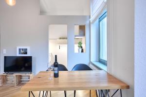 a room with a table with a bottle of wine on it at seeglueck Altstadt Urban in Konstanz