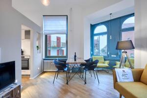 a living room with a table and chairs at seeglueck Altstadt Urban in Konstanz