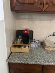 a kitchen counter with a red appliance on a counter top at Casa vacanze Pezzoli in Rovato
