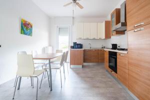 a kitchen with a table and chairs in a room at Villa Livia in Toscolano Maderno +20 photos