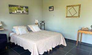 a bedroom with a bed with a white bedspread at la ferme au bois dormant in Wemaers-Cappel