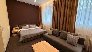 a hotel room with a bed and a couch at Готель Гоголь in Poltava