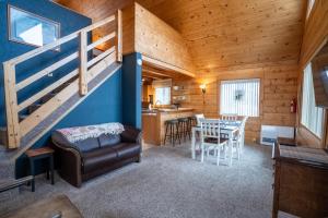 a living room with a staircase in a cabin at Hatcher Pass Cabins in Palmer
