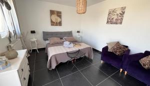 a room with a bed and a table and a chair at la ferme au bois dormant in Wemaers-Cappel