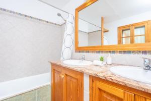 a bathroom with two sinks and a mirror at Es Coll d'en Pastor in Fornalutx +27 photos