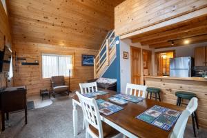 a kitchen and dining room with a table and chairs at Hatcher Pass Cabins in Palmer