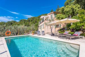 a swimming pool in front of a house at Son Bou in Sóller
