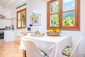 a kitchen with a table with baskets of fruit on it at Son Bou in Sóller