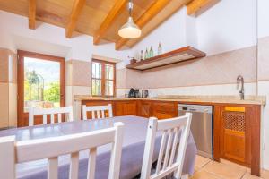 a kitchen with a table and chairs in a room at Can Raia in Sóller +27 photos