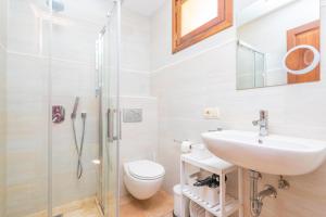 a bathroom with a sink and a toilet and a shower at Can Raia in Sóller