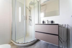a bathroom with a glass shower and a toilet at Villa Livia in Toscolano Maderno