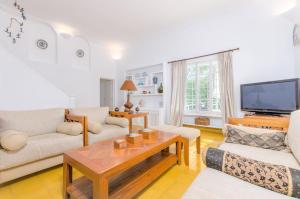 a living room with two couches and a tv at Cala Dor 14 in Cala d´Or