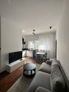 a living room with a couch and a table at Villa Masoneria in Łódź