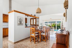 a kitchen and dining room with a table and chairs at Villa Ca Mestre Rafel by Escape Home in Santo Tomás