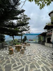 a group of benches sitting on a stone patio at Elephant homestay in Sapa