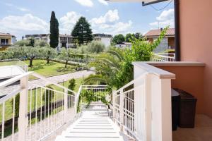 a view from the balcony of a house with white stairs at Villa Livia in Toscolano Maderno