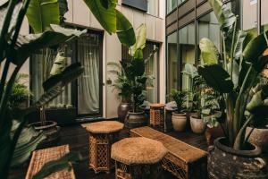 a patio with tables and potted plants in a building at Torel Palace Porto in Porto