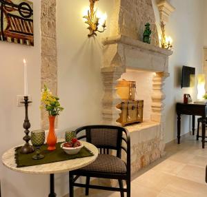 a dining room with a table and a fireplace at Domus Settecento in Putignano