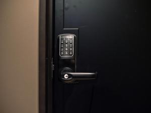 a black door with a remote control on it at SHIFT HOTEL Shibuya Jinnan in Tokyo