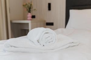 a stack of white towels on a bed at Fewo Mauterndorf in Mauterndorf