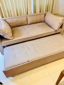 a brown couch sitting in a living room at Adventure Condo Aonang in Ao Nang Beach