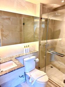 a bathroom with a toilet and a glass shower at Adventure Condo Aonang in Ao Nang Beach +11 photos