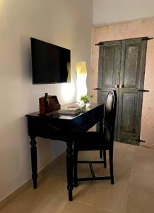 a desk with a computer and a chair with a monitor at Domus Settecento in Putignano