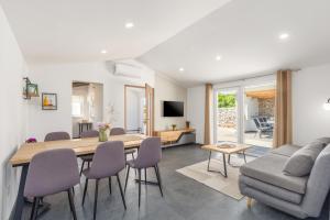 a dining room and living room with a table and chairs at House Prenc in Pazin
